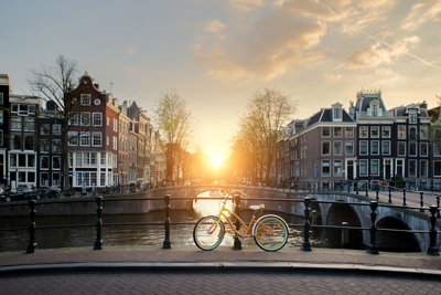 scenic canal shot and bike against railings in Amsterdam